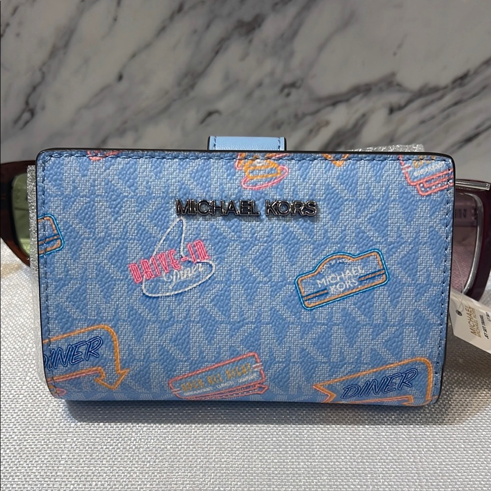 Michael Kors Jet Set Travel Medium Printed Signature Logo Bi-Fold Wallet
LT SKY